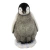 Baby Stands Watching Penguin Figurine